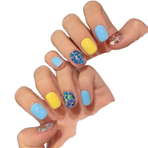 Minimalist sequin press-on nails in blue and yellow colors with mermaid glitter finish
