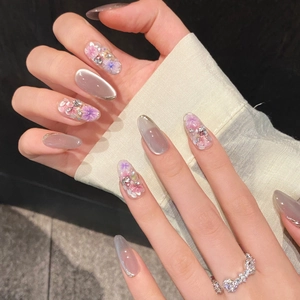 Handmade almond press-on nails with purple dried flowers and silver cat-eye finish