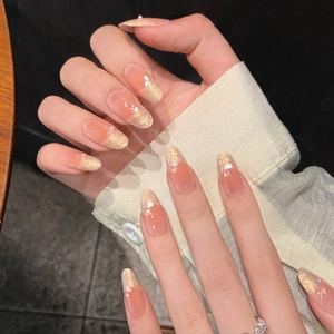 Almond press-on nails with pink-yellow gradient, pearls, and iridescent shimmer finish