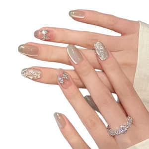 Silver cat eye press-on nails with pink base, 3D lines, and geometric rhinestone accents