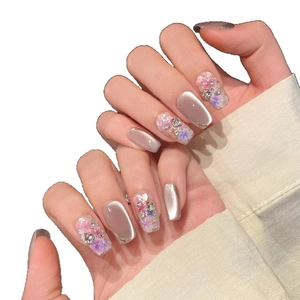 Champagne cat-eye press-on nails with handmade 3D floral accents and sparkling rhinestones