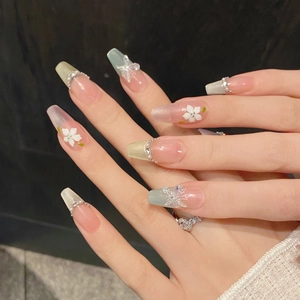 French cat eye press-on nails with 3D white flowers and butterfly charms in coffin shape
