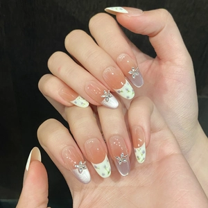 Hand-painted purple flower press-on nails with pink blush gradient and star rhinestones