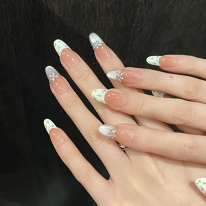 Handmade press-on nails with purple floral patterns and silver butterfly rhinestones