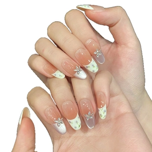 Long almond press-on nails with purple floral patterns and silver 3D metal flowers