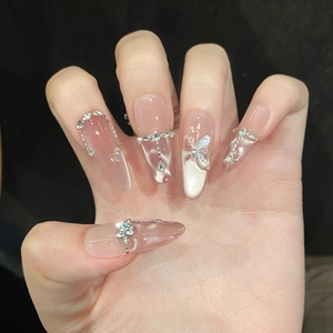 Sparkling pink cat-eye press-on nails with 3D butterfly, rhinestones and metal chain decor