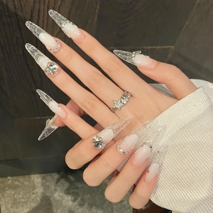 Elegant long stiletto press-on nails with pink gradient and lace patterns with rhinestones
