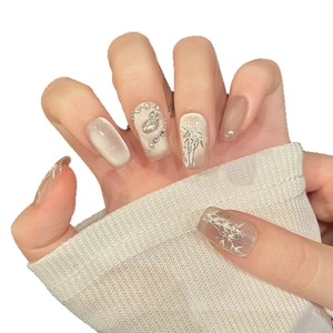Cat eye press-on nails with champagne gold bamboo pattern and crystal embellishments