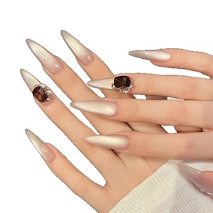 Elegant champagne cat eye stiletto press-on nails with luxury brown gems and crystals