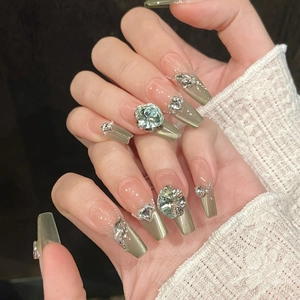 Handmade cat eye green press-on nails with large rhinestones and pearls in long coffin shape