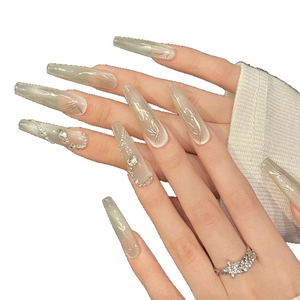 Chic green cat eye press-on nails with silver bamboo patterns and hand-set crystals