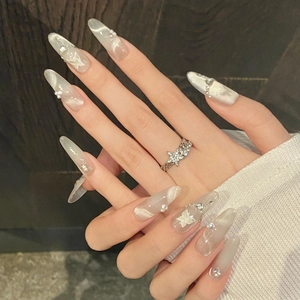 Cat eye press-on nails with silver butterfly and pearl accents in long almond shape