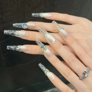 Silver cat-eye press-on nails in long coffin shape with rhinestones and glitter finish