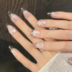 Pink cat-eye press-on nails with 3D floral petals, pearls and rhinestones on almond shape