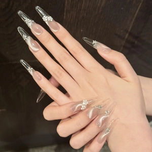 Handmade champagne cat-eye press-on nails with 3D white flowers and sparkling rhinestones