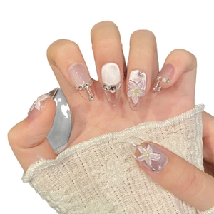 Handmade almond press-on nails with 3D flower petals, cat eye effect and rhinestones