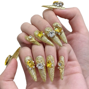 Luxury gold glitter stiletto press-on nails with yellow crystals and star charms