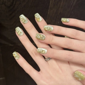 Handmade press-on nails with green cat-eye finish and gold crystal stone accents
