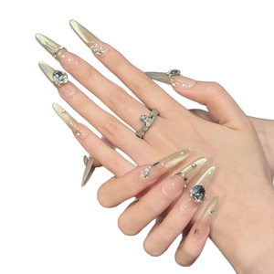 Champagne gold cat-eye press-on nails with luxury rhinestones and pearl accents