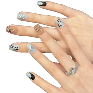Handmade press-on nails with 3D floral carving, pearls, and black line art on almond shape