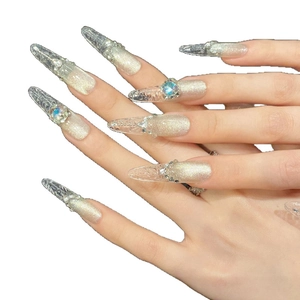Silver cat-eye stiletto press-on nails with ice-transparent texture and stacked rhinestones