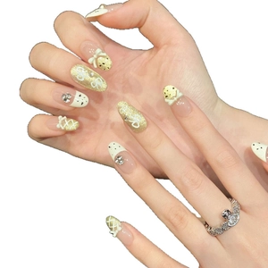 French cream white press-on nails with golden glitter, bow designs and rhinestones