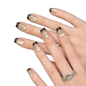 Short French cat-eye press-on nails with 3D floral carving and champagne glitter finish