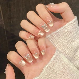 Champagne cat eye press-on nails with silver butterfly zircons and glitter accents