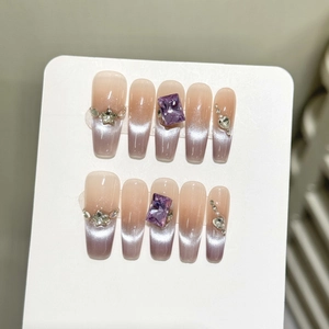 Handmade cat eye press-on nails in purple gradient with luxury crystal decorations