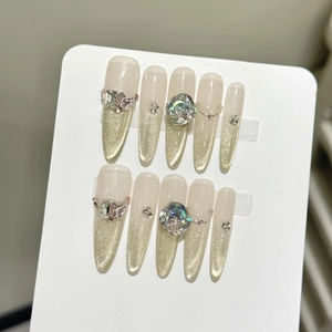 Luxury almond press-on nails with champagne cat-eye glitter and 3D butterfly charms