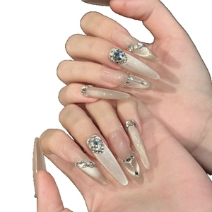 Sparkling stiletto press-on nails with champagne cat-eye finish and rhinestones