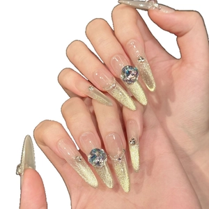 Luxury almond press-on nails with gold cat-eye gradient and sparkling rhinestones