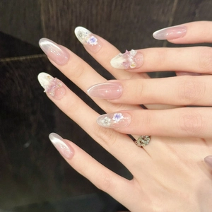 Floral cat-eye press-on nails in pink gradient with butterfly 3D accents