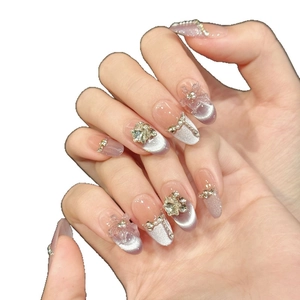 Purple cat eye press-on nails with 3D floral accents and sparkling rhinestone details