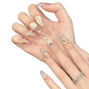 Handmade champagne cat-eye press-on nails with 3D resin bows and pearl accents