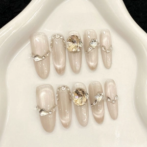Press-on nail set featuring champagne cat-eye effect with rhinestones and heart gems
