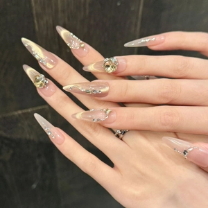 Sparkling stiletto press-on nails with champagne cat-eye glitter and luxury rhinestones