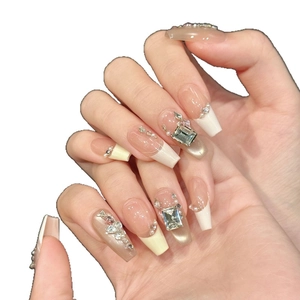Pink and white cat-eye press-on nails with luxury rhinestones and pearl accents