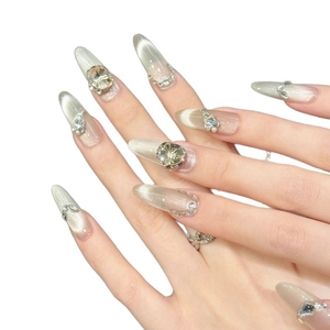 Sparkling pink cat-eye press-on nails with luxury rhinestones and pearls in almond shape
