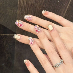 Faux ongles cat-eye roses avec motifs floraux 3D, perles et strass brillants