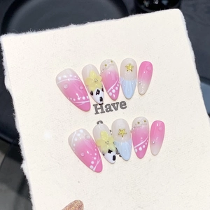 Detailed view of pink gradient handmade press-on nails with 3D starfish and pearls