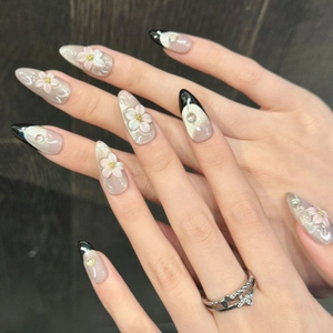Pink cat eye press-on nails with 3D floral carving and French tips in almond shape