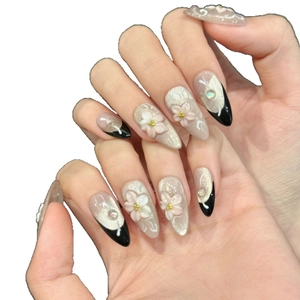 Pink cat eye press-on nails with 3D floral carving and French tips on almond shape
