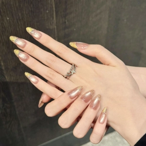 Pink cat eye french nails with gold glitter gradient in long almond shape