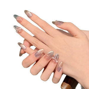 Cat eye press-on nails in grey-purple almond shape with 3D bows and water droplets