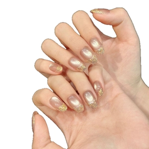 Pink cat eye press-on nails with gold glitter French tips and oval shape design