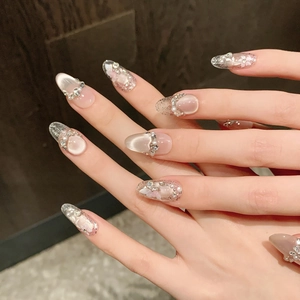 Exquisite cat-eye press-on nails with pearls, rhinestones, and floral art for a dreamy look