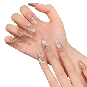 Elegant cat-eye press-on nails with floral art and pearl accents in soft pink finish