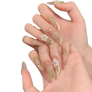 Champagne green cat-eye press-on nails with 3D white flowers and sparkling rhinestones
