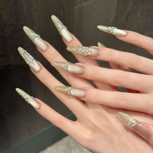 Sparkly champagne nude stiletto press-on nails with crystal accents and glitter gradient